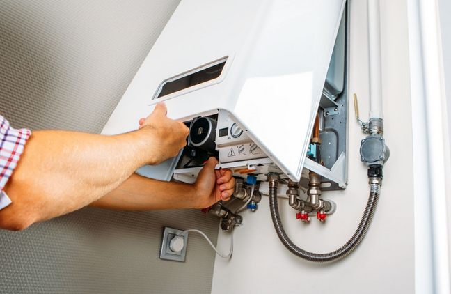 Heating engineer installing new boiler