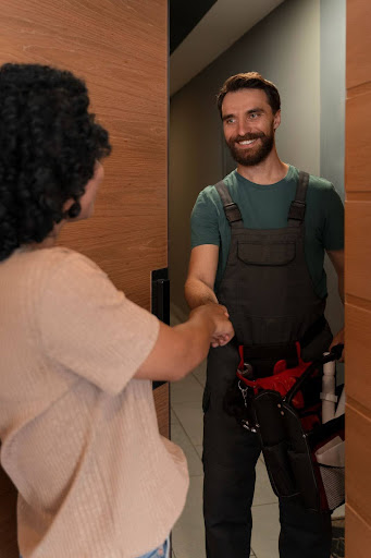 engineer shaking hands with customer in home